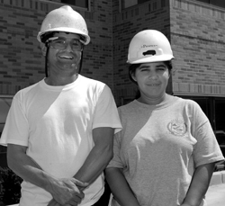 Photo of two CRC construction workers smiling for the camera
