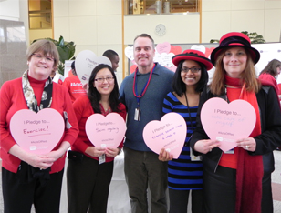 Staff and patients holding paper hearts
