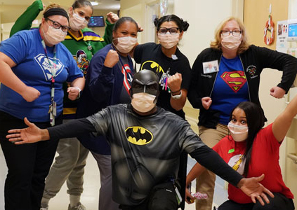 staff in superhero costumes