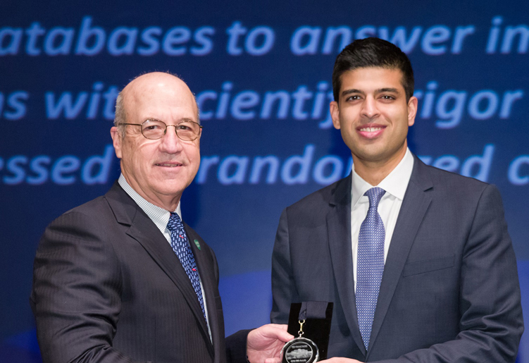 Dr. James Gilman congratulates Dr. Samir Kadri