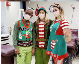 three people in holiday outfits