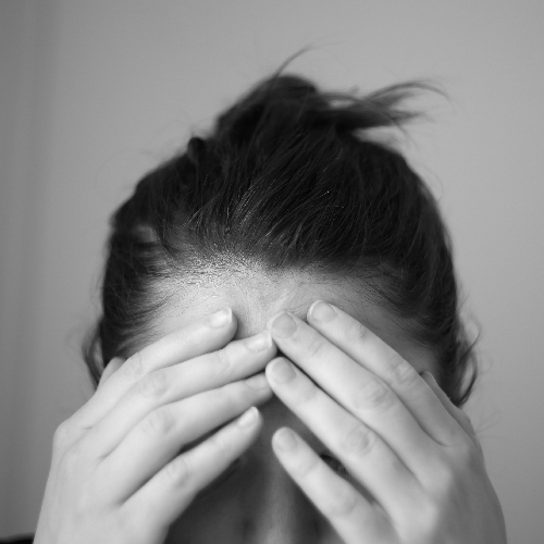 person with head in hands