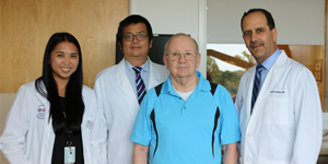 Patient standing with care providers