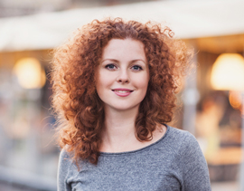 A woman smiling, representing energy and well-being