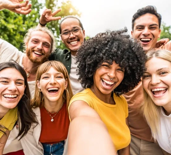 A group of young adult friends smiling while posing for a photo