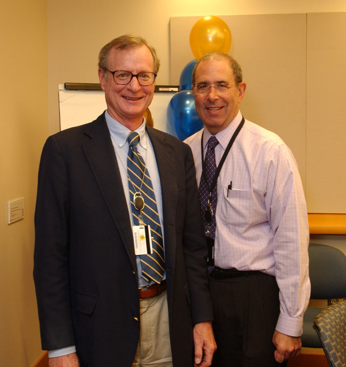 Dr. Arthur Atkinson (left), with CC director John I. Gallin, retires from NIH after leading the ClinPRAT program for seven years. 