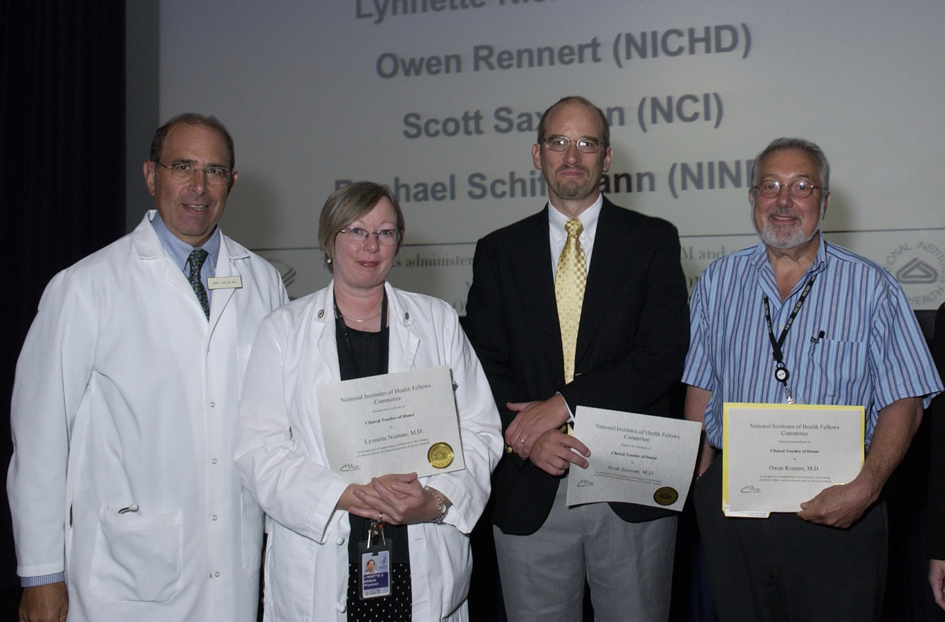 Dr. John Gallin, CC director (left), congratulates Clinical Teacher Award winner Dr. Lynnette Nieman and two of the finalists, Drs. Scott Saxman and Owen Rennert.