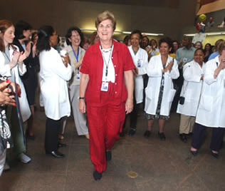 Her colleagues applaud as nurse Alice Rosenberg walks to the stage to receive her award.