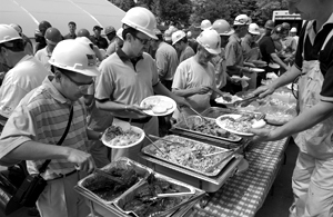 Photo of construction workers helping themselves at the Appreciation Luncheon buffet