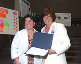 Nurse Clara Moore of the adult behavioral health unit receives her award from presenter Clare Hastings.
