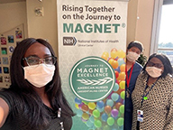 Nurses standing with Magnet banner
