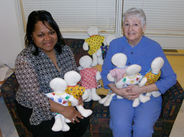 Dorothy Wilson (right), mother of CC employee Debra Byram, worked for six weeks to create the 100 handmade dolls she donated to CC pediatric patients. Felicia Andrews (left), nurse manager, accepted the gift on behalf of the pediatric unit. 