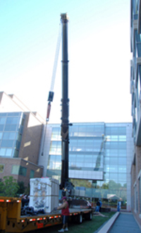 A crane arrived at the CC to lift out the old cyclotron and lower the new one.