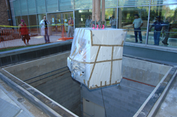 The new cyclotron is lowered into the access shaft connecting to the basement.