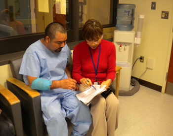 Interpreter volunteer helps a patient