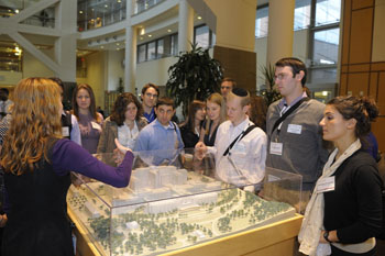 Rachael Schacherer hosts a group of fellows at the Clinical Center model in the Hatfield atrium