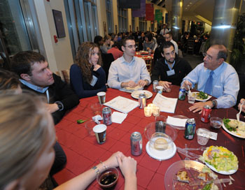 Dr. Gallin talks with a table of fellows over dinner in Natcher Conference Center