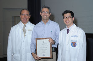 Dr. John Gallin (left) and Dr. Joo Song (right) present Dr. Jeffrey Baron (middle) with the 2010 Distinguished Clinical Teacher Award. Baron holds the plaque.