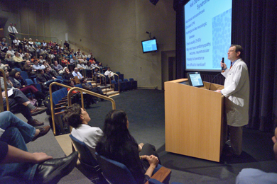 Dr. Steven Holland speaking at a podium