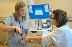 A nurse scanning a patient's barcode.