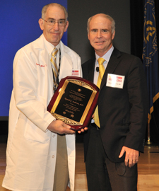 Dr. Harvey G. Klein presenting an award to Dr. Kenneth C. Anderson