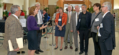 Dr. Frederick P. Ognibene and Denise Ford talking with sixteen Norwegian hospital presidents