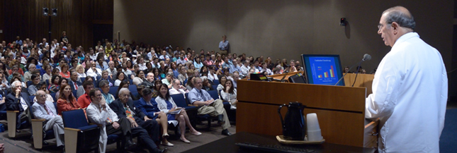 Dr. John I. Gallin speaking to a large audience