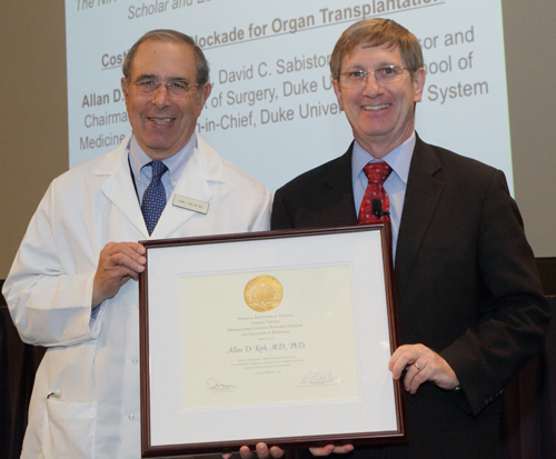 Dr. John I. Gallin, left, and Dr. Allan D. Kirk holding a plaque