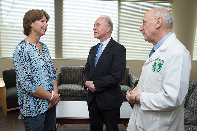 Price (center) speaks with Judy Perkins (left), patient in the Clinical Center, after a discussion of her case with Dr. Steven A. Rosenberg, chief of surgery at the National Cancer Institute.