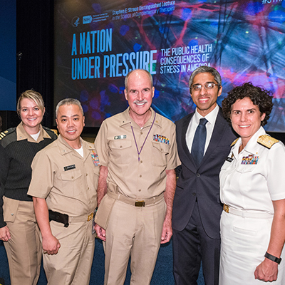 Four members of the Public Health Service stand with Dr. Vivek Murthy