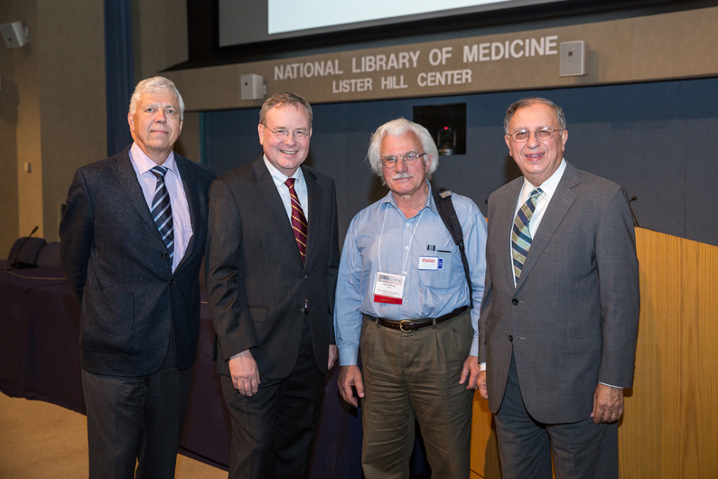 Four men pose for a picture at the Red Cell Genotyping Symposium