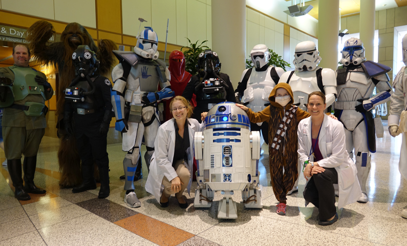 Star Wars characters posing with two doctors and a patient