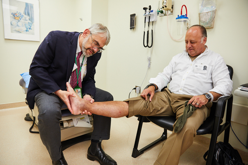 Dr. Daniel Kastner examining a patient at the NIH Clinical Center