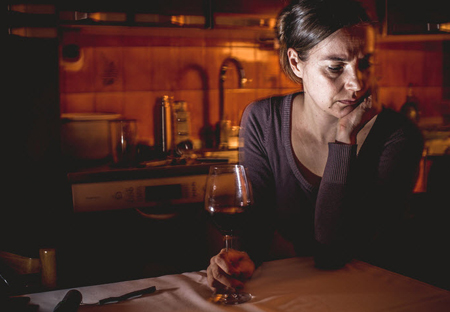 A woman drinking alone