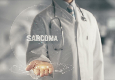 Graphic of a man in a white coat with his palm up. The word sarcoma floats above his palm