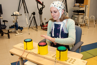 Woman with scientific cap on her head plays a touch game.