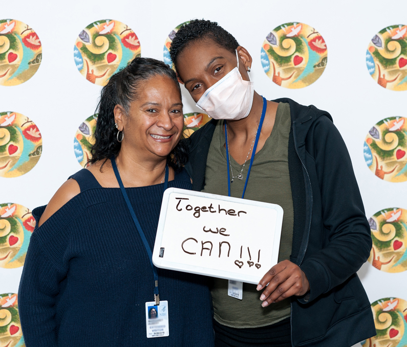 Patient with caregivers participate in 2017 Caregiver Day photo booth