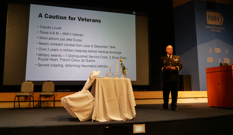 Dr. James Gilman, CEO of the NIH Clinical Center and a retired Army major general, speaks as the keynote speaker the 2017 NIH Veterans Day Celebration Nov. 9 at the NIH Clinical Center