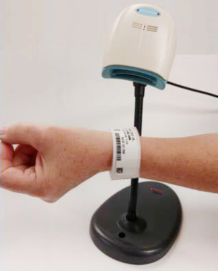 a patient's wristband getting scanned upon checking in or out
