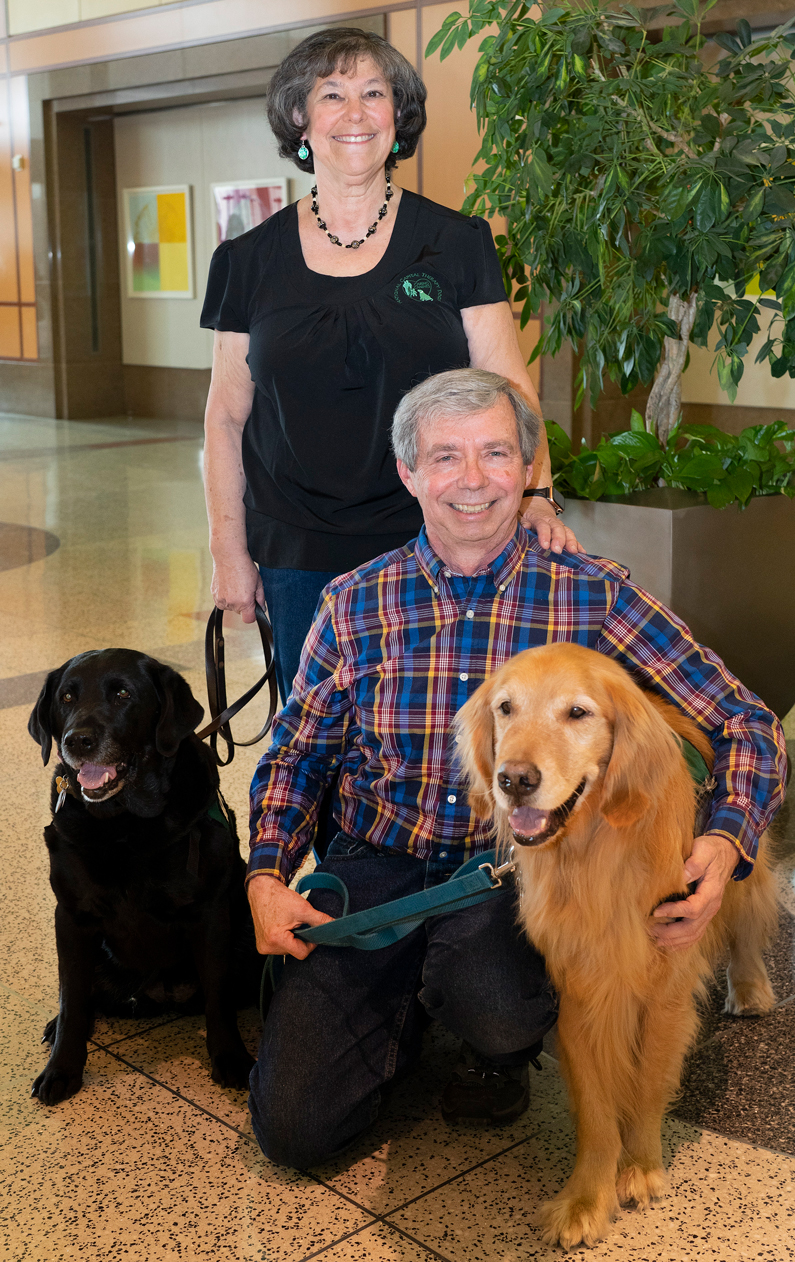 Dave and Sandy Gill and their therapy dogs, Toby and Cindy Bear and Rosko (not pictured), visit patients at the NIH Clinical Center