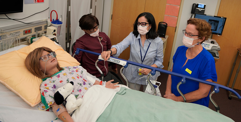 Hospital staff in simulated patient room