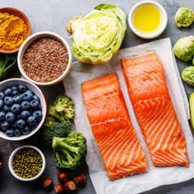 a table spread with salmon and other healthy foods