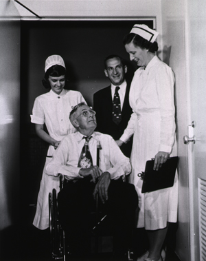 Charles Meredith, the first patient admitted to the Clinical Center, with nurses