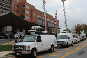 News trucks outside the NIH Clinical Center