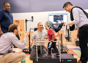 Inside the NIH Clinical Center's Rehabilitation Medicine Department, a team of doctors, engineers, technicians, and physical therapists have gathered to map the brain activity of a two-year-old clinical trial participant named Ethan.