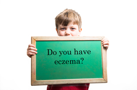 A child holding a sign that reads Do you have eczema?