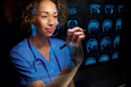 a doctor examining MRI scans