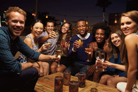 a group of people at a party drinking alcohol